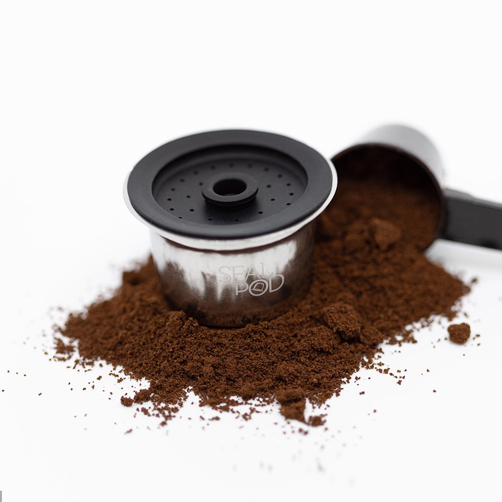Feepod stainless steel pod silicon cover and scoop sitting in coffee grinds (4156360491059)